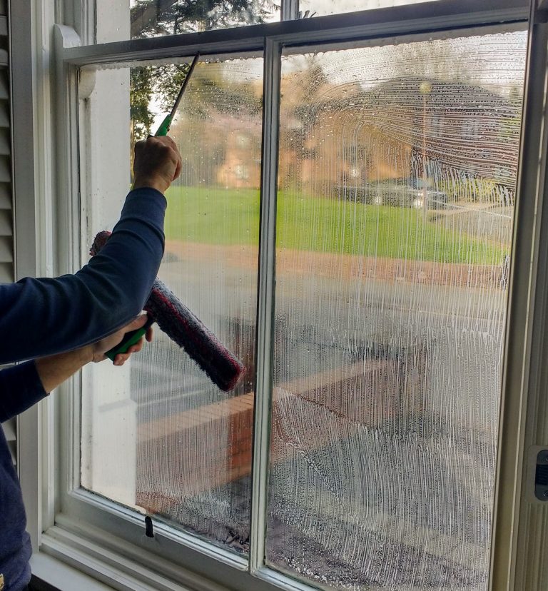 Inside window cleaning with a mop and squeegee